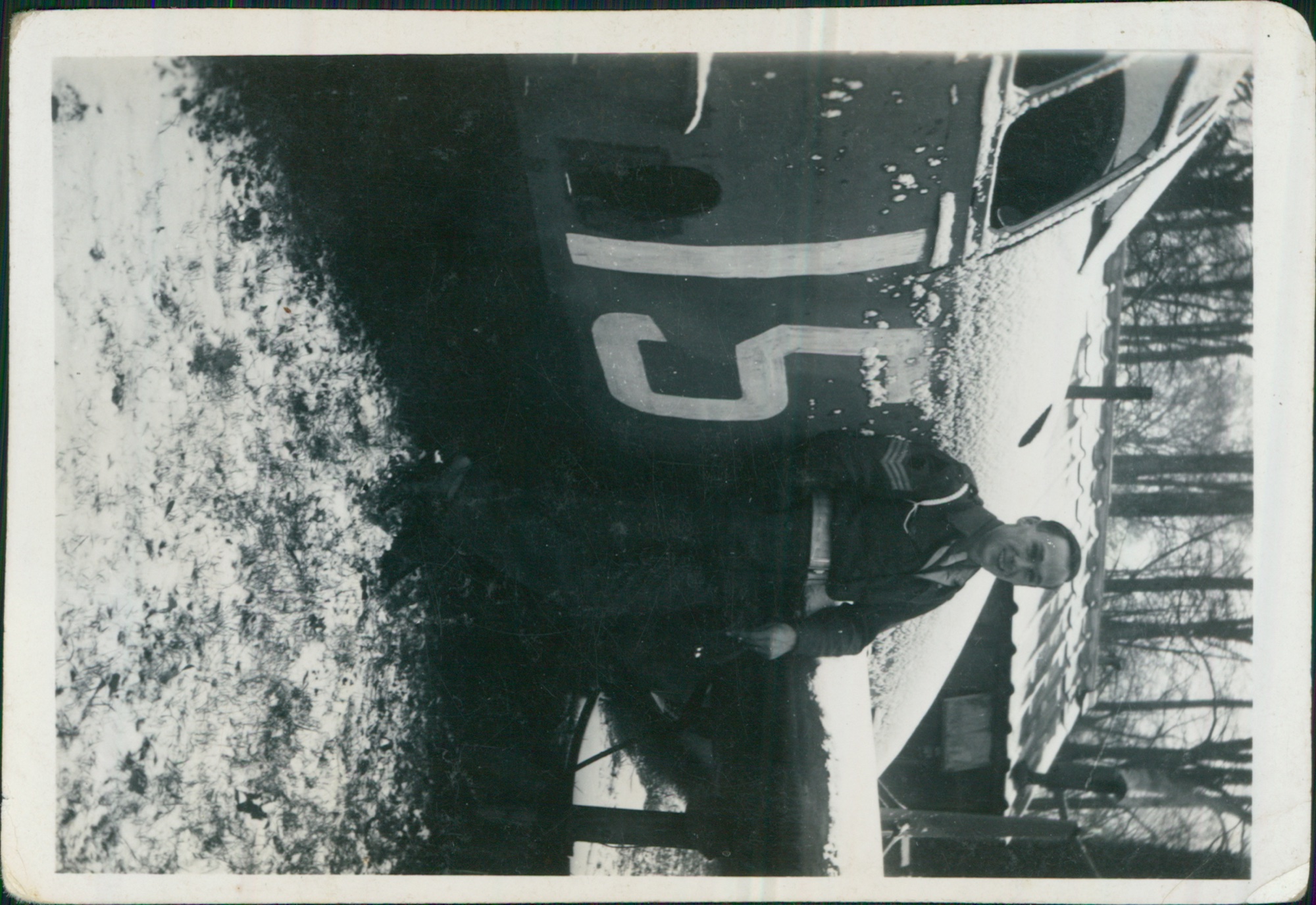 Sergeant Charles Cable Savage in winter battledress before a military lorry, NW Europe 1944-45